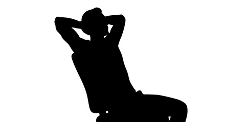 Silhouette of a person sitting relaxed in a chair with hands behind head conveying calmness and serenity in a simple modern setting