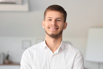Handsome young happy businessman working in office