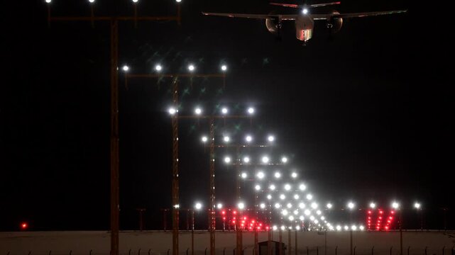 Stockholm, Sweden A plane lands at night in winter on a runway at Arlanda Airport.