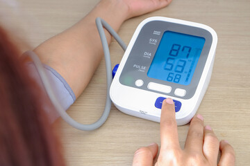Man check blood pressure monitor and heart rate monitor with digital pressure gauge. Health care and Medical concept	
