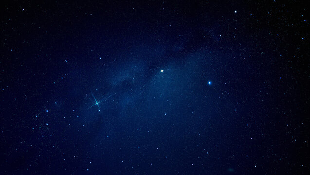 Dark blue night sky with bright stars and nebula