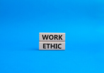Obraz premium Work Ethic symbol. Concept words Work Ethic on wooden blocks. Beautiful blue background. Business and Work Ethic concept. Copy space.