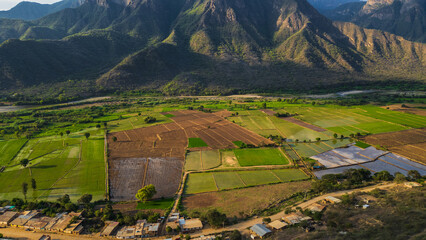 Aerial drone panoramic sunset landscape of Mayasc&oacute;n, Lambayeque, with mountains and rural fields in northern Peru, ideal for social media, marketing, graphic design, and scenic wallpapers