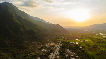 Aerial drone panoramic sunset landscape of Mayasc&oacute;n, Lambayeque, with mountains and rural fields in northern Peru, ideal for social media, marketing, graphic design, and scenic wallpapers