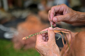 Indigenous Australians female hands weaving artwork