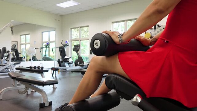 close-up of a woman performing leg extensions on a machine