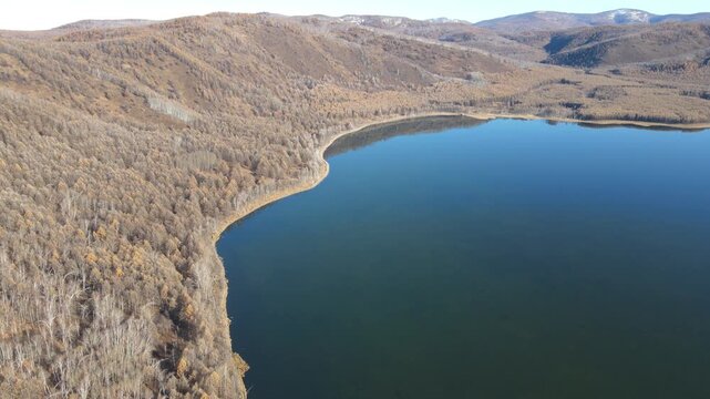 Aerial Pull Back Revealing Halaha River and Forest Valley in Autumn, Inner Mongolia, China