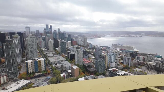 Gimbal wide panning shot of the Seattle skyline from the observation deck of the Space Needle during autumn in Washington. 4K at 30 FPS