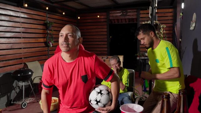 Soccer fans celebrating a goal and rivals disappointed