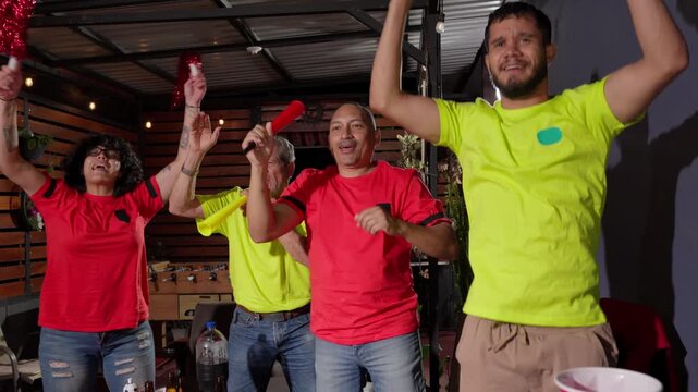 Enthusiastic soccer fans celebrating a goal together