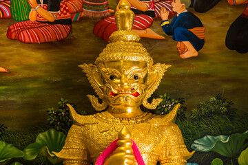 Fototapeta premium Golden Deity Statue: A close-up shot of an intricate, golden statue of a deity, its stern expression and elaborate ornamentation showcasing the rich cultural heritage and artistic mastery.
