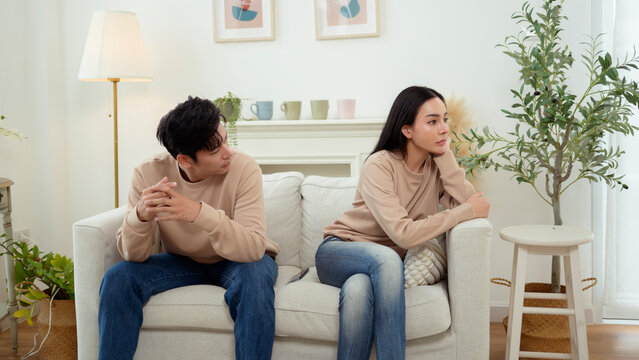 Quarrel Between Asian Couple Revealing Issues of Infidelity and Emotional Distance in a Cozy Setting