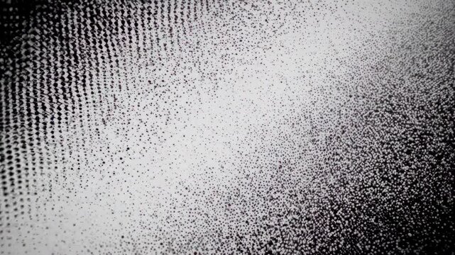 Microscopic view of a patterned surface transitioning from sparse dots to dense formations