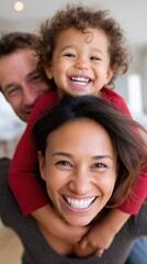 Happy multiethnic family with parents and child laughing together while playing piggyback at home.