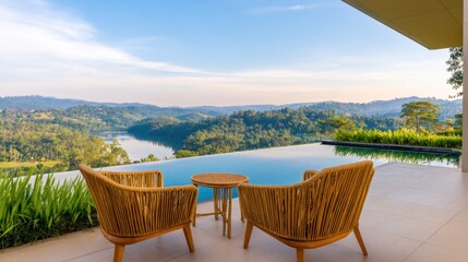 Obraz premium Luxurious terrace with wicker chairs overlooks an infinity pool and rolling hills under a clear blue sky today