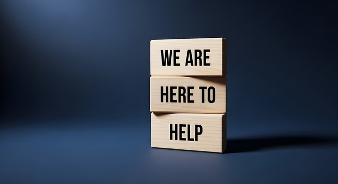 Wooden blocks stacked vertically with the reassuring message we are here to help printed clearly in black bold font against a dark blue background symbolizing support and customer service commitment