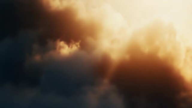 Dark, heavy cumulus cloudscape with dramatic contrast as warm golden sunlight pierces stormy gray and orange skies, creating an ethereal, powerful atmospheric scene