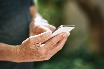 Hands, phone and typing at park with contact, chat or check notification with texting in summer....