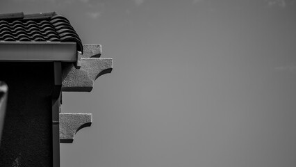 Architectural details of a stucco house facade are captured in monochrome © Cam