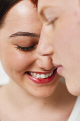 Closeup of smiling woman and man touching heads with eyes closed, showing happiness and affection...