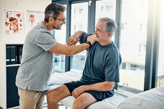 Senior man, physiotherapist and stretching shoulder for assessment, mobility and injury recovery. Mature person, elderly patient and help with stiff joints, physical therapy and muscle rehabilitation
