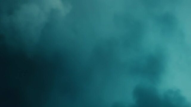 Soft focus clouds floating across a gradient teal and blue sky creating an abstract, dreamy atmosphere, often representing tranquility, freedom, and openness