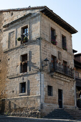 Historic stone building with balconies and flowers.. Santillana del Mar, Santander, Spain