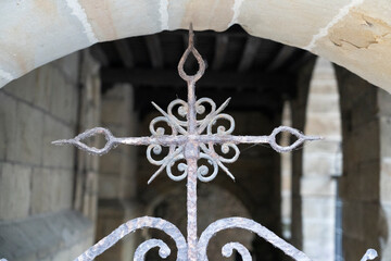 Wrought iron cross with intricate design.. Santillana del Mar, Santander, Spain