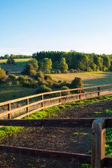 Beautiful rural sunset landscape in the green fields meadows in the Cotswolds, England