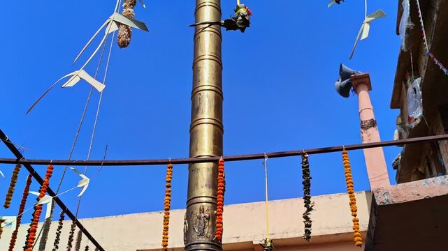 Dwajasthambam with temple gopuram and decorated flowers at Balaji Temple, kodangal, tandur, telangana, india. day time, tilt down shot, 4k.