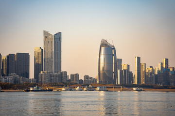 Naklejka premium Modern skyscrapers and city skyline along the river in Wuhan China