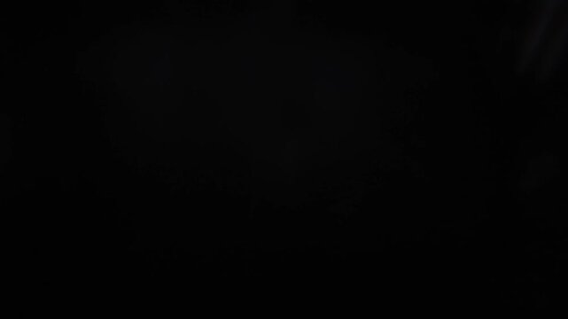 4k prism light effect on black background. Glowing dreamy lights, bokeh lens flare, abstract refraction of sunlight prism effect, cinematic light leak overlay texture. Dreamy Light refraction effect