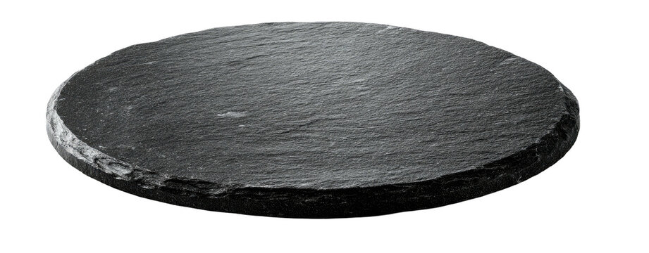 A close-up, isolated image of a dark gray, circular serving slate plate on a black background