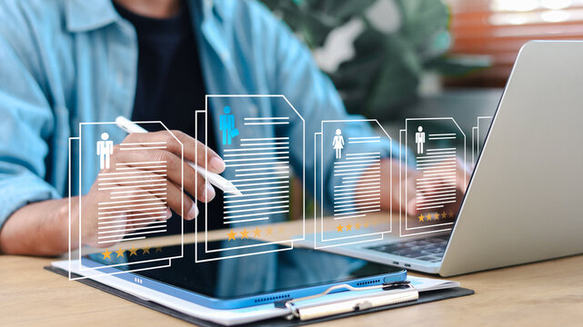 Business professional reviewing multiple candidate profiles with star ratings on digital tablet. Concept of HR evaluation, recruitment, performance review, and talent management.