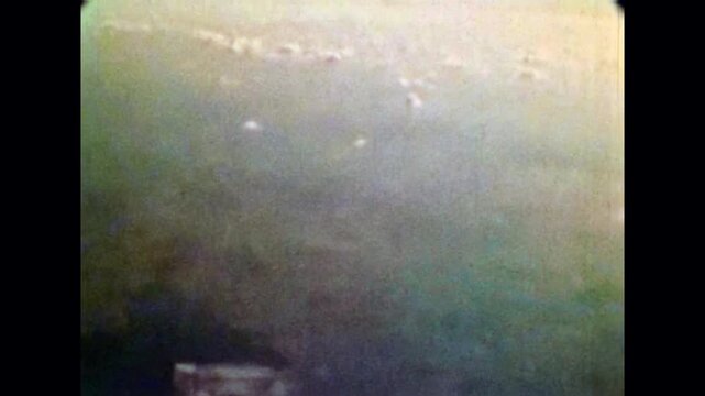 Old film, Flying above white clouds, top view from airplane. Fluffy cloudscape going into distance toward horizon. Nature sky background. Freedom in air travel. Archival retro. Vintage archive