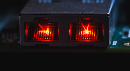 Macro Close-up of Dual Ethernet RJ45 Ports Glowing Red on Circuit Board. Network Connectivity, Data Transmission, and Digital Technology Infrastructure Background.