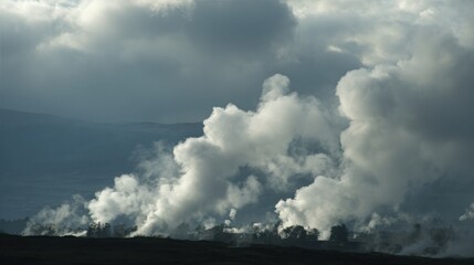 Obraz premium Billowing white steam rising from industrial cooling towers amidst dramatic clouds, hinting at geothermal energy production