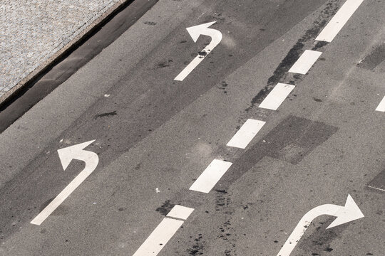 Road arrows and lane markings on asphalt in Copenhagen Denmark showing traffic transport infrastructure and urban direction concept