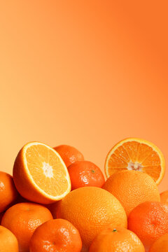 Fresh Oranges and Tangerines on Orange Background.