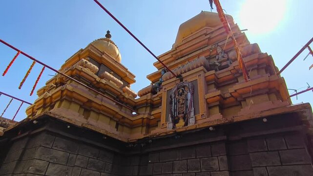 Divine view of Vimana Venkateswara Swamy on the shikhara of Kodangal Sri Mahalakshmi Venkateshwara Swamy temple with sun and sky. day time, stable shot, 4k.