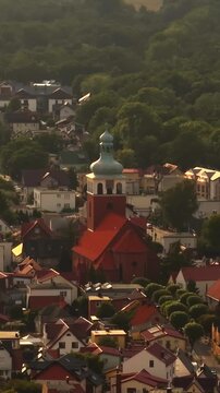 Vertical drone shot around the Kości&oacute;ł pw. Nawiedzenia NMP church, in Jastarnia, Poland