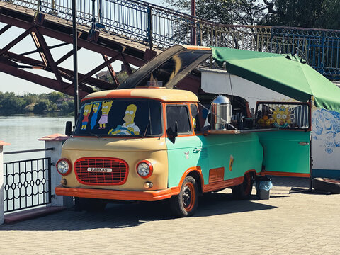 Samar, Ukraine &ndash; July 15, 2025: vintage food truck featuring The Simpsons decals by the river in summer