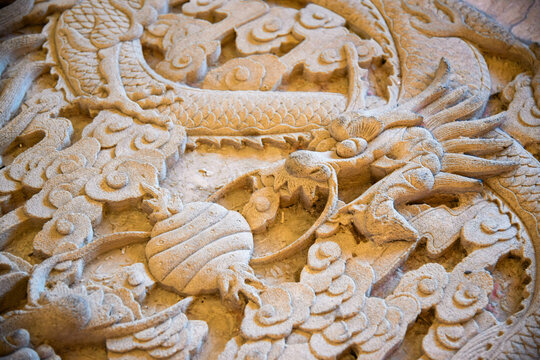 Carved Stone Dragon Relief with Traditional Asian Ornamental Details