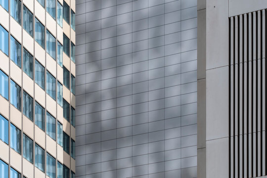 Modern architecture facade with windows metal grid and lines casting shadow geometry for abstract corporate highrise building exterior detail
