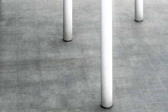 Minimal concrete architecture with columns and space using lines shadow and texture to create geometry and abstract modern interior background