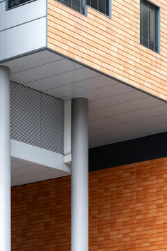 Modern architecture facade with brick wood column at corner showing texture geometry and abstract design in clean urban daylight background