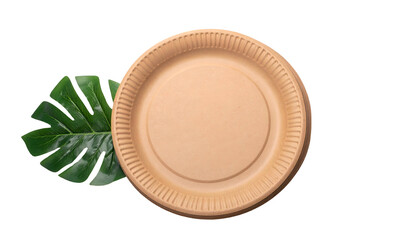 Top-down shot of a brown paper plate and a large green leaf, on a black backdrop