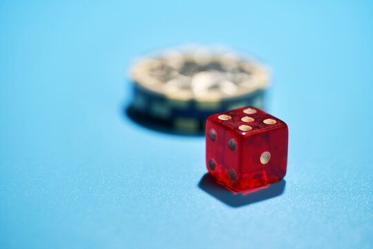 cloce up of gamblering chip and dice on blue background