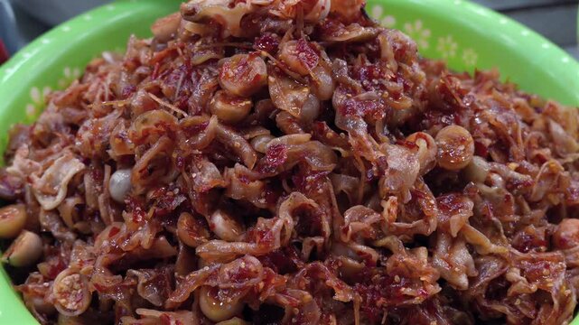 
This image shows Mam Tom Chua, a Hue specialty of fermented sour shrimp mixed with chili, galangal, and crunchy green papaya.