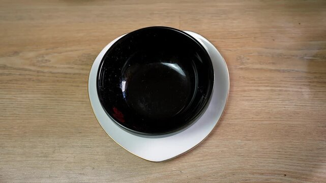 Black Bowl on White Plate on Wooden Table assorted nuts